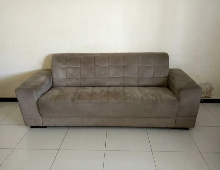 Worn leather sofa with grime before cleaning